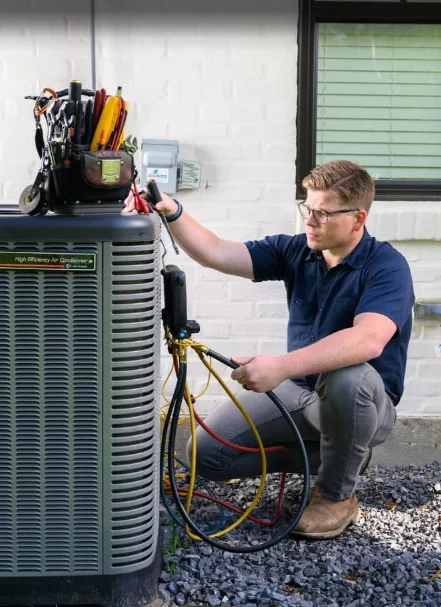 Next Phase technician working on an outdoor AC unit